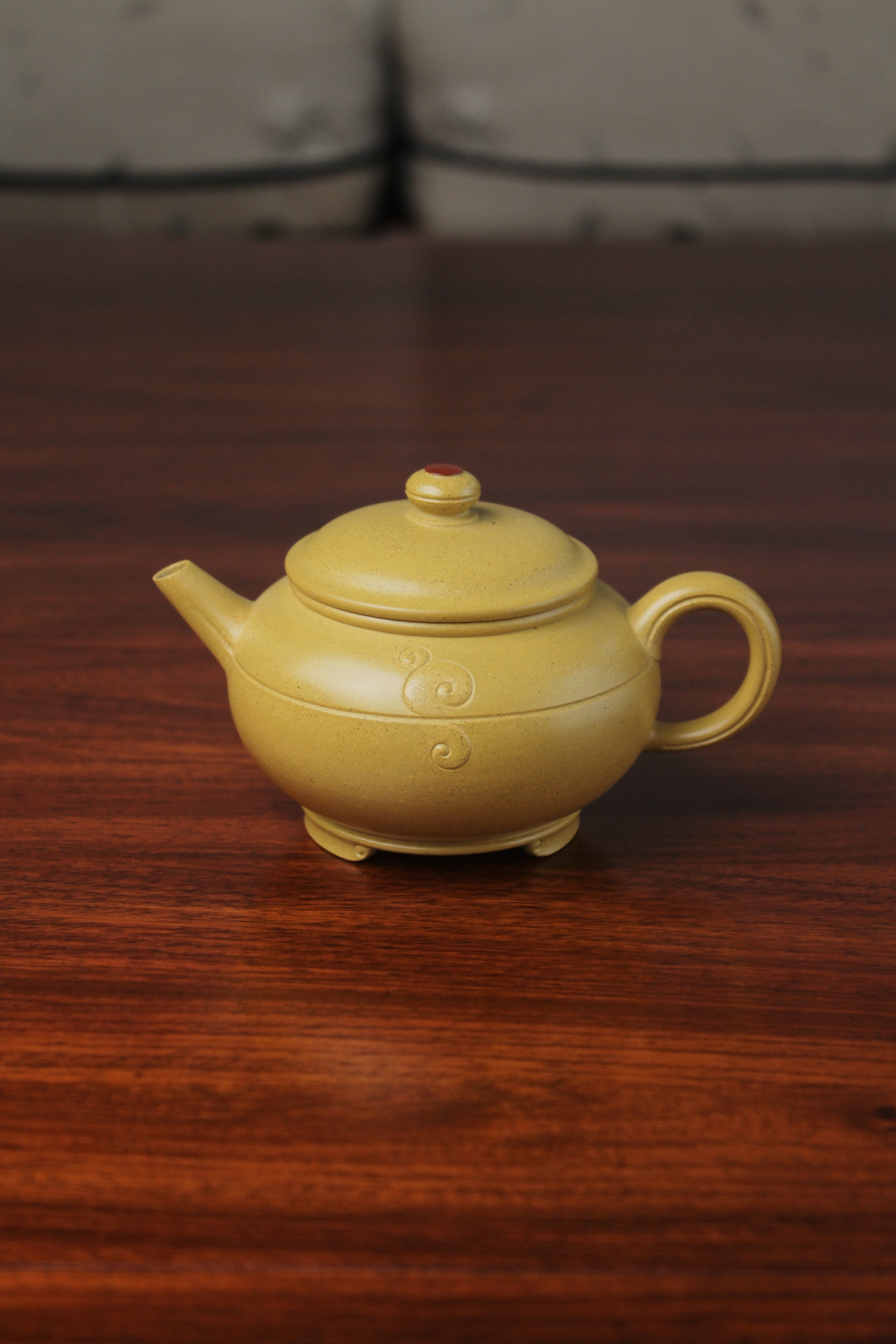 the zisha teapot on the table, handmade with purple clay from teapot art zisha art gallery